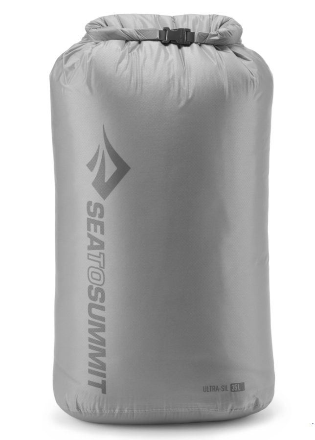 dry bag gray, stuffed to the top and sealed.