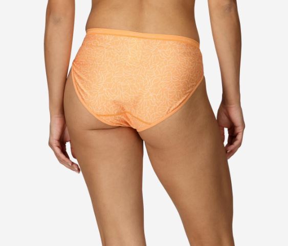 Ex Officio Women's Give-N-Go 2.0 Bikini Brief in the pattern bellini mosaic (peach with geometric patterns), worn by model, back view