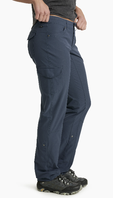 A side-profile view of a person wearing dark slate blue cargo pants, a gray t-shirt, and hiking shoes against a plain white background.
