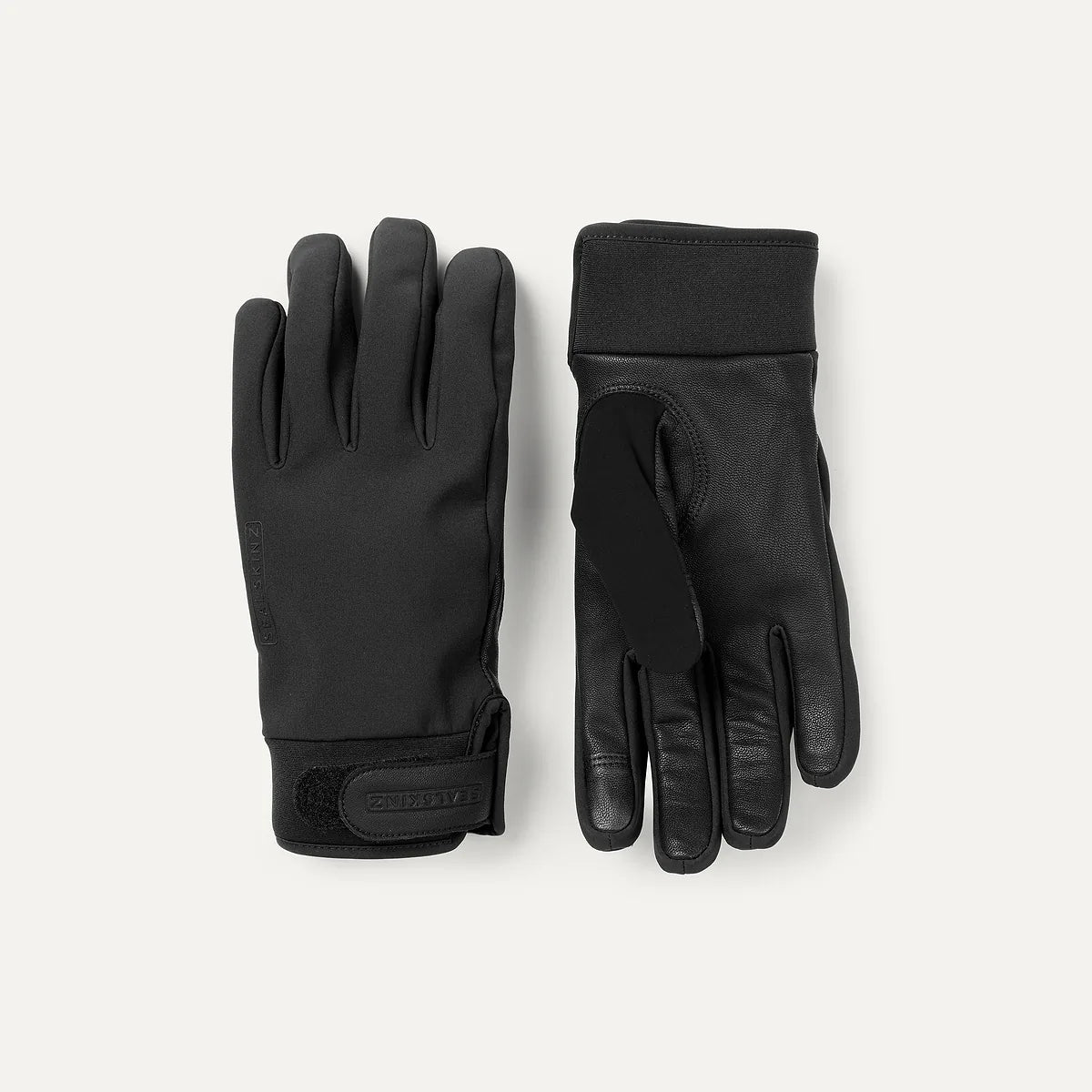 Pair of black gloves on a light gray background