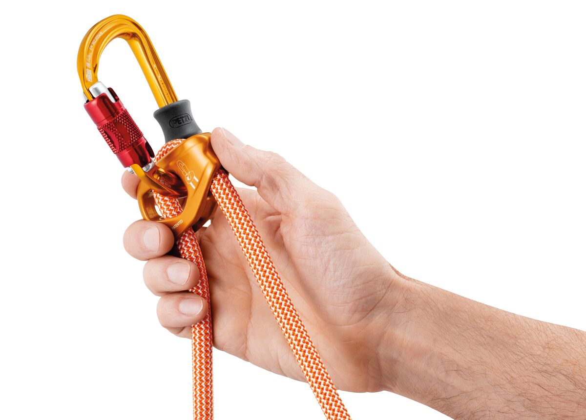 Hand holding the petzl connect adjust with orange rope on a white background