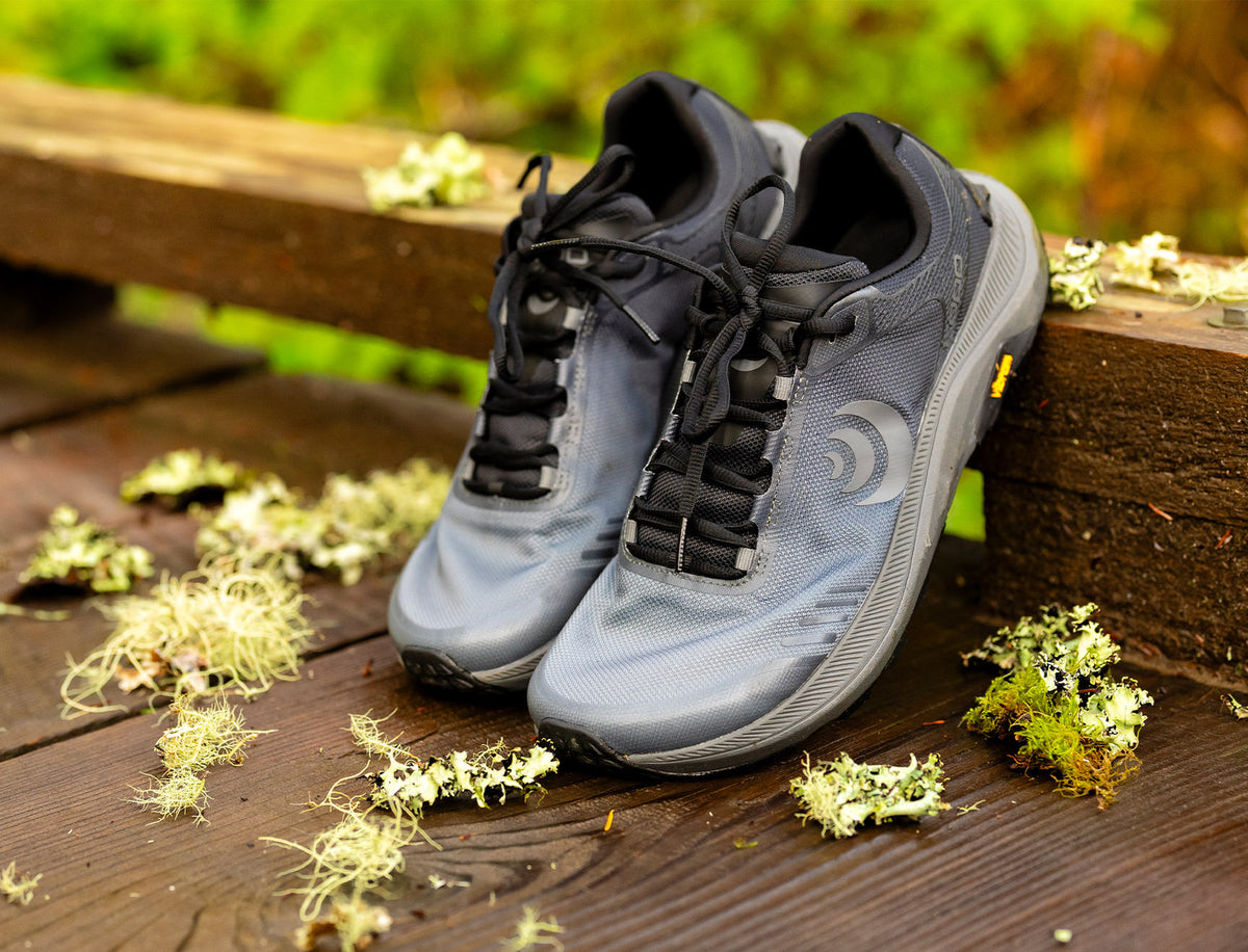 a pair of mt 5s rest on a boardwalk railing