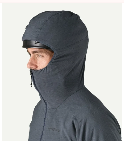 MAN WEARING HOODY WITH HOOD OVER HELMET 