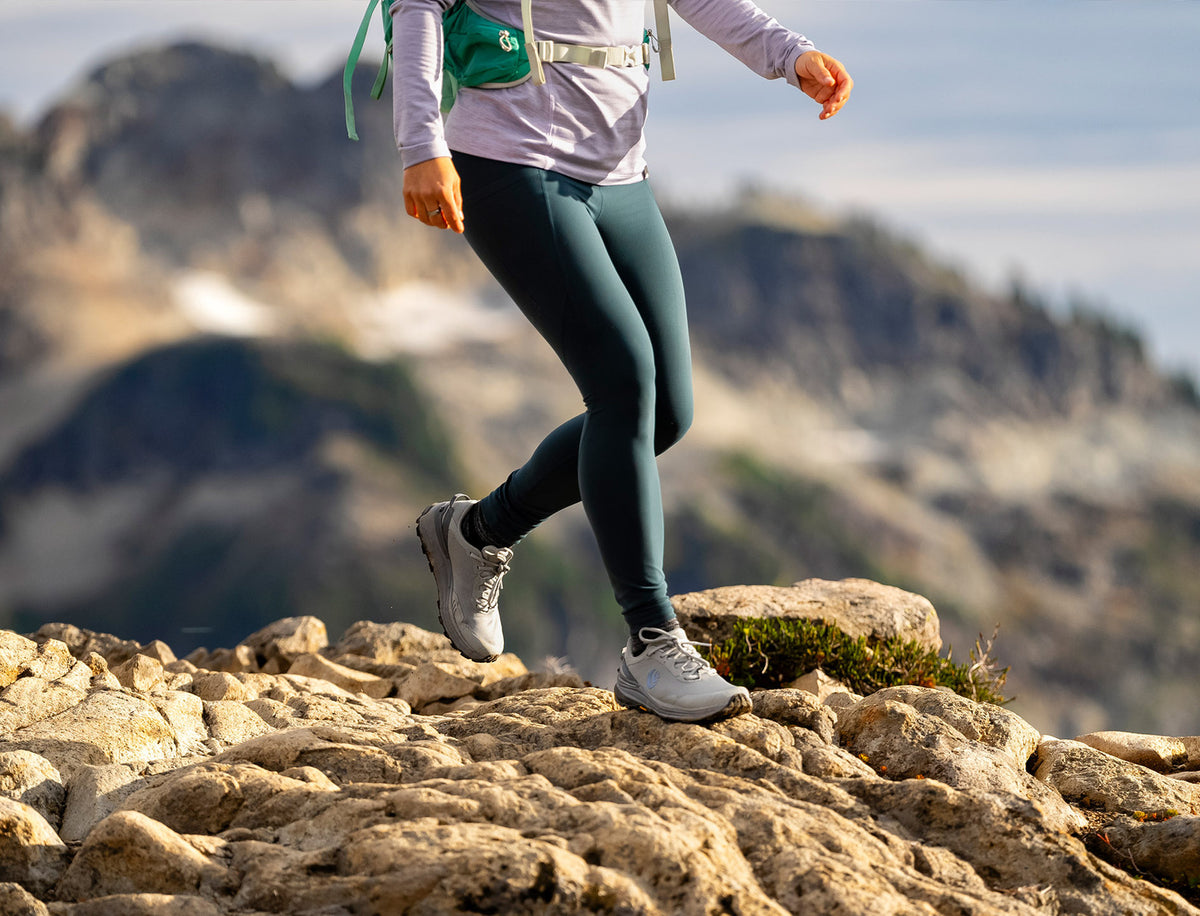 life style image of a person walking across some rocks