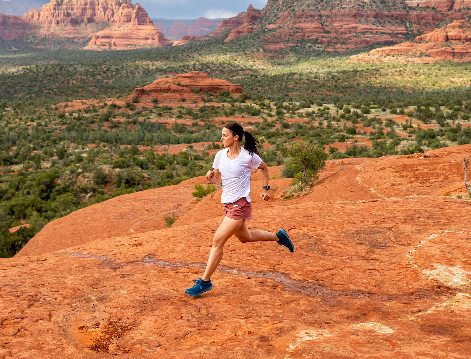 lifestyle showing woman running in what looks like Utah