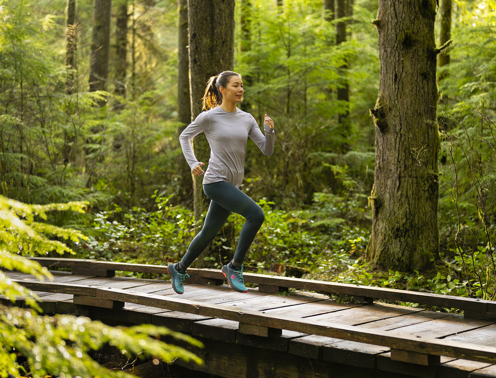 a woman runs on a boardwalk