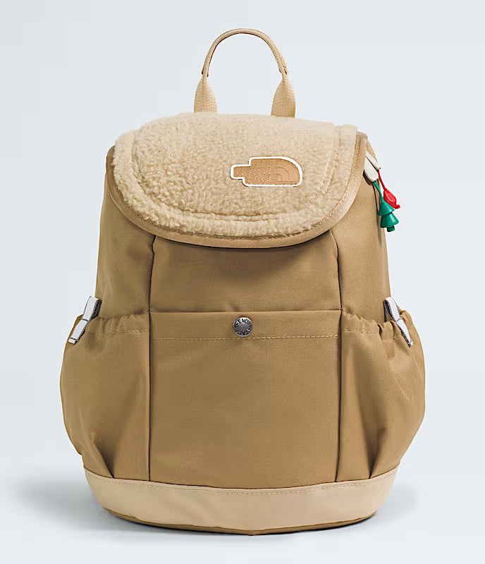 Beige backpack with a sherpa-like top on a light gray background