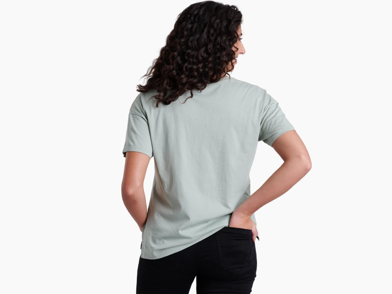 The kuhl womens waves short sleeve tee shirt on a model in the color agave, back view