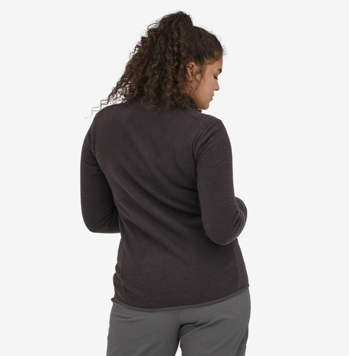 a photo of the patagonia r1 air zip neck in the color black, back view on a model