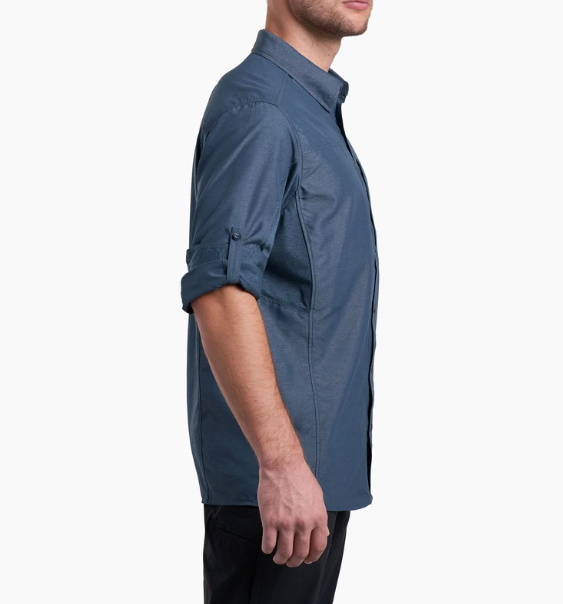 a model wearing the kuhl airspeed long sleeve mens shirt in the color pirate blue, side view