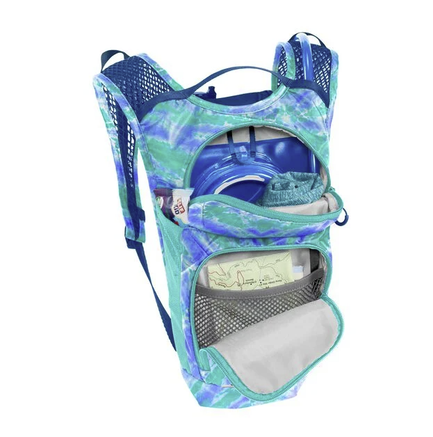 the camelbak mini mule in tie dye blue, front view with things in open pockets