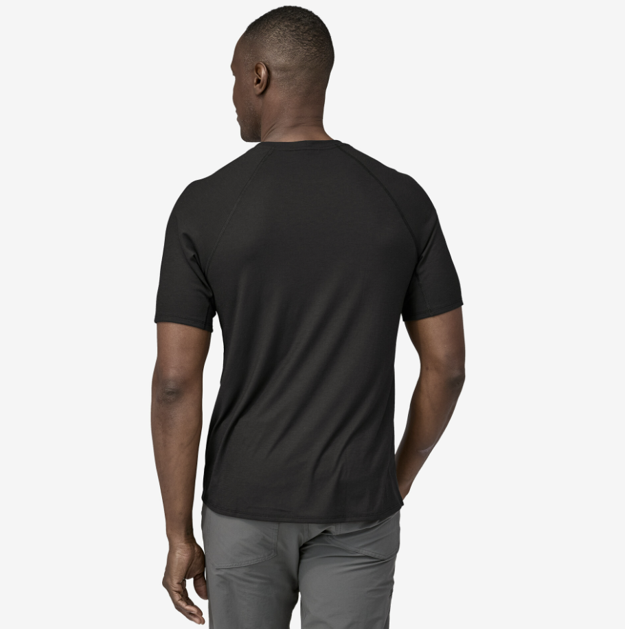 patagonia mens capilene cool trail tee shirt in the color black, back view on a model