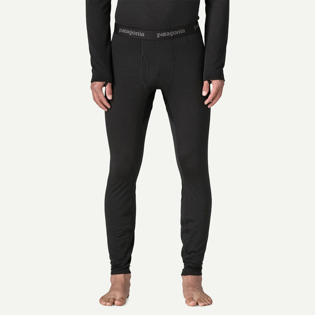 person wearing black thermal bottoms with bare feet