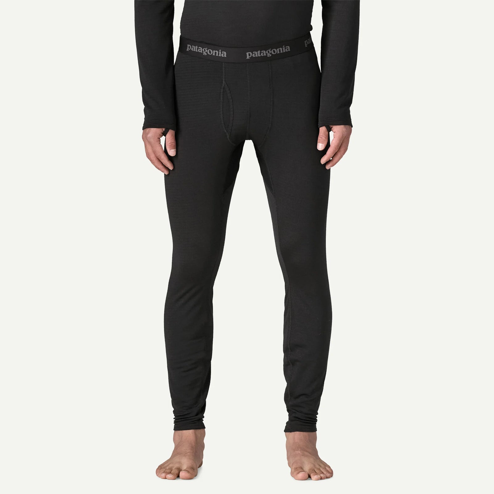 person wearing black thermal bottoms with bare feet
