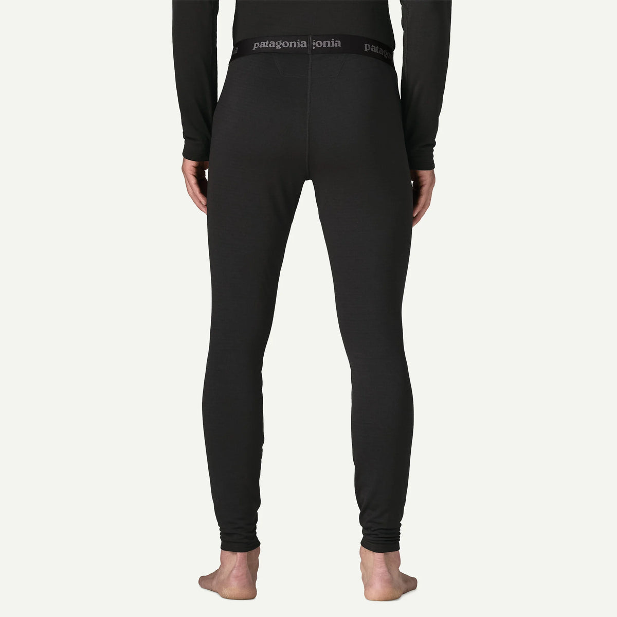 person wearing black thermal bottoms with patagonia logo on the waistband 
