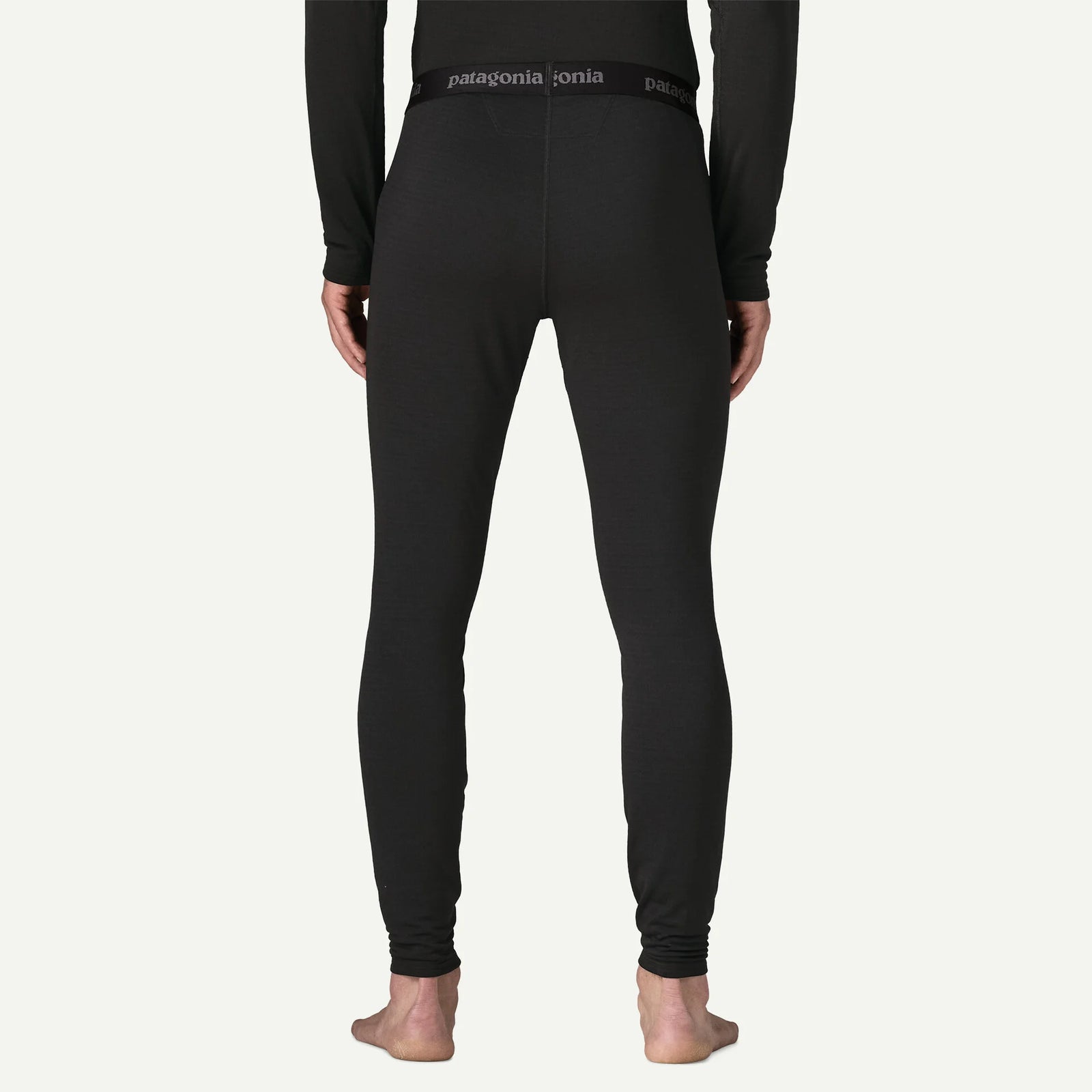 person wearing black thermal bottoms with patagonia logo on the waistband 