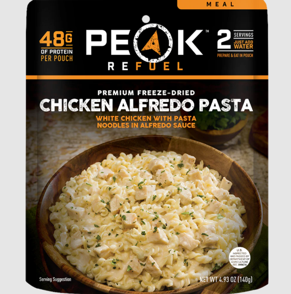 Package of Peak Refuel Chicken Alfredo Pasta with a bowl of pasta in the background