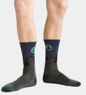 darn tuff pct micro crew sock on a model standing funny