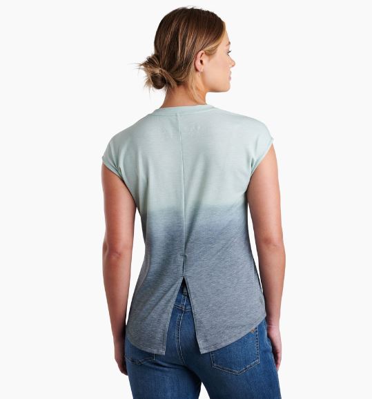 a model wearing the kuhl womens isla short sleeve shirt in the color eucalyptus, back view