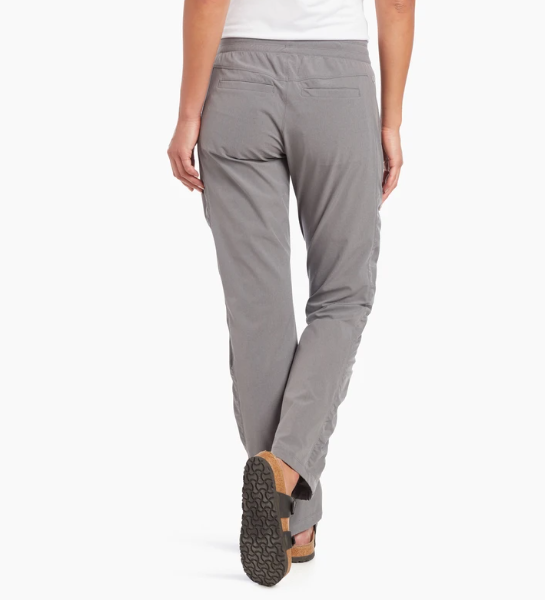 a model wearing the kuhl freeflex move pant in the color flint, back view