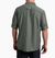 a model wearing the kuhl airspeed long sleeve mens shirt in the color dark forest, back view