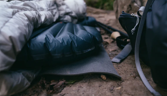 gossamer thinlight rolled pad being used under an inflatable sleeping pad