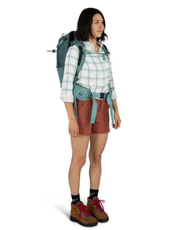 a photo of the osprey mira 22 pack in the color succulent green, front view on a model