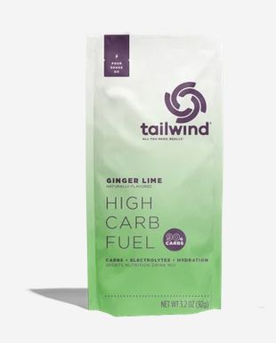 A 3.2 oz pouch of tailwind High Carb Fuel in Ginger Lime flavor, featuring a white-to-light-green gradient design with purple branding and text.