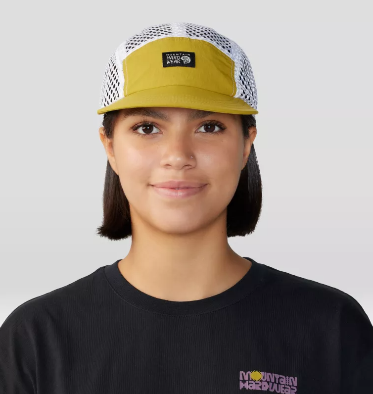 a model wearing the mountain hardwear stryder hike hat in the color dark citron