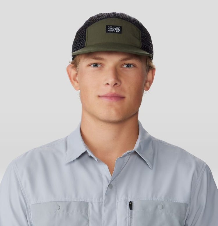 a model wearing the mountain hardwear stryder hike hat in the color dark pine