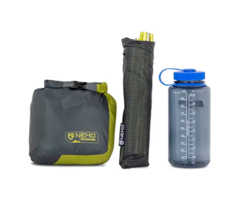 the nemo hornet tent showing the tent stuffed and the poles next to a one liter water bottle