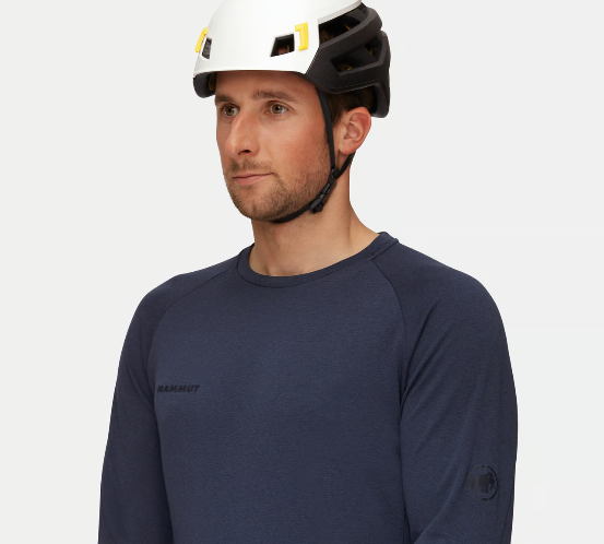 an awkward model wearing the mammut wall rider mips helmet
