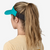 the patagonia airshed visor in the color subtidal blue, back view on a model