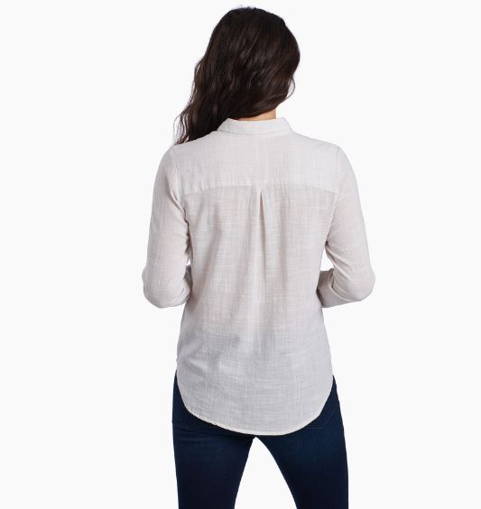 a model wearing the kuhl adele long sleeve shirt in natural back view