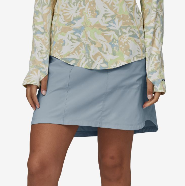 a photo of the patagonia womens tech skort in the color steam blue, alternate front view on a model