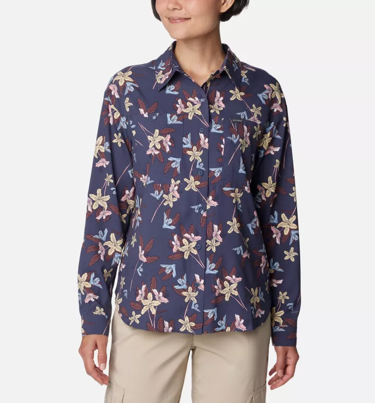 a model wearing the columbia womens silver ridge utility patterned long sleeve shirt in the color nocturnal tiger lilies, front view