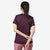 a photo of the patagonia womens capilene cool daily shirt in the color night plum obsidian plum x dye, back view on a model