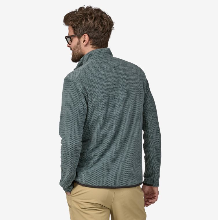 the patagonia r1 air zip neck mens jacket in the color nouveau green, back view on a model