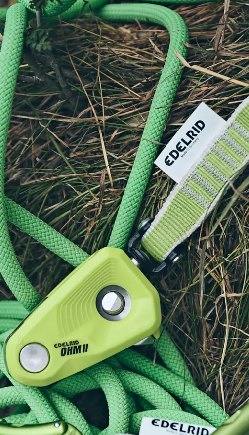 the edelrid ohm 2 shown in the grass and some rope