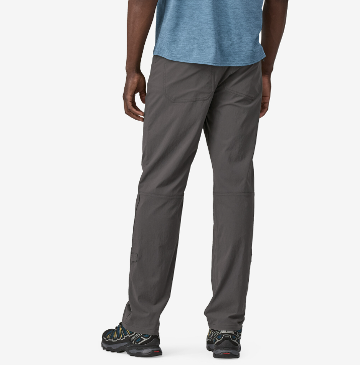 the patagonia mens quandary pant in the color forge grey, back view on a model