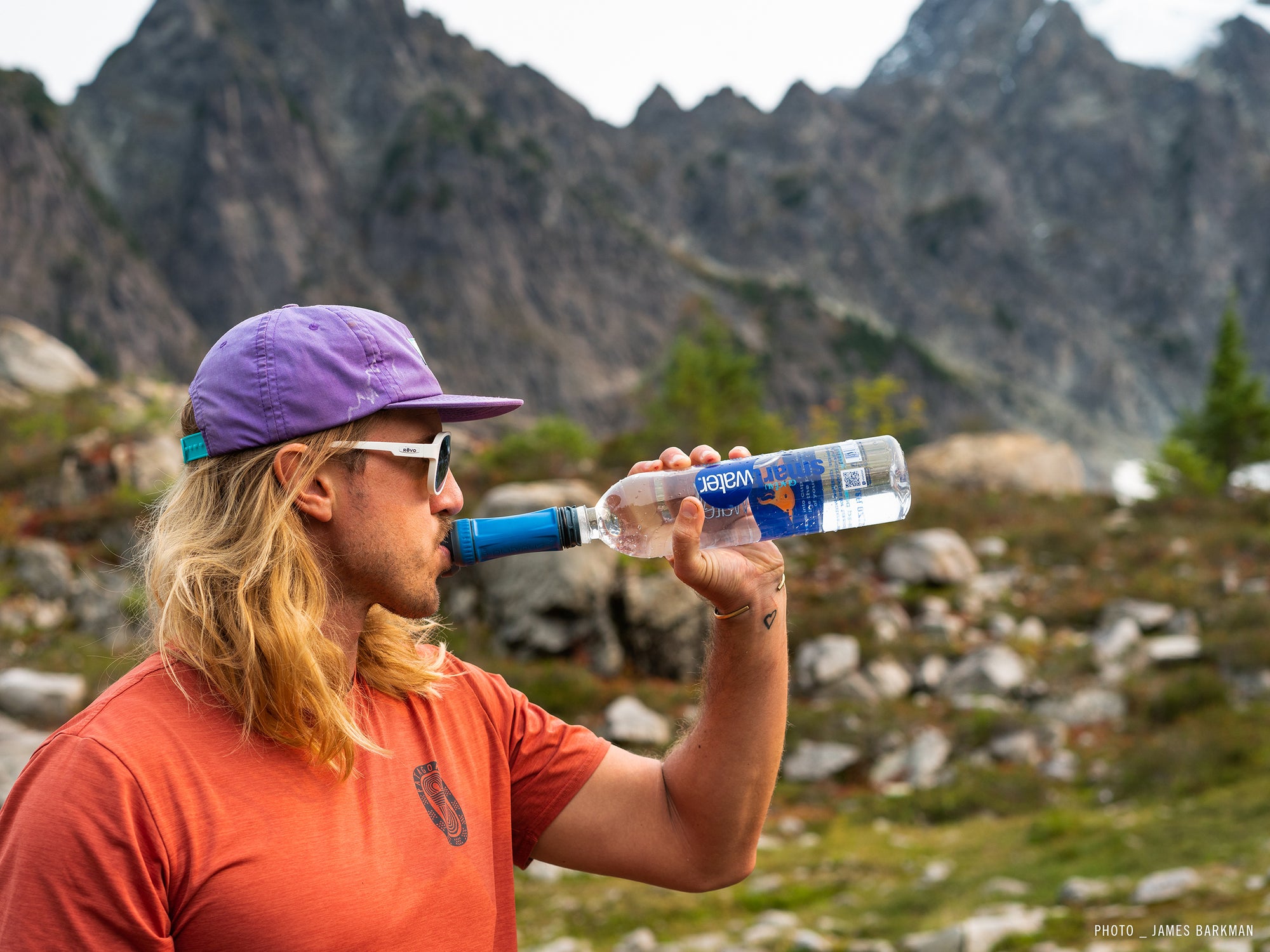 Platypus Quickdraw Filter on a water bottle, model drinking straight from filter.