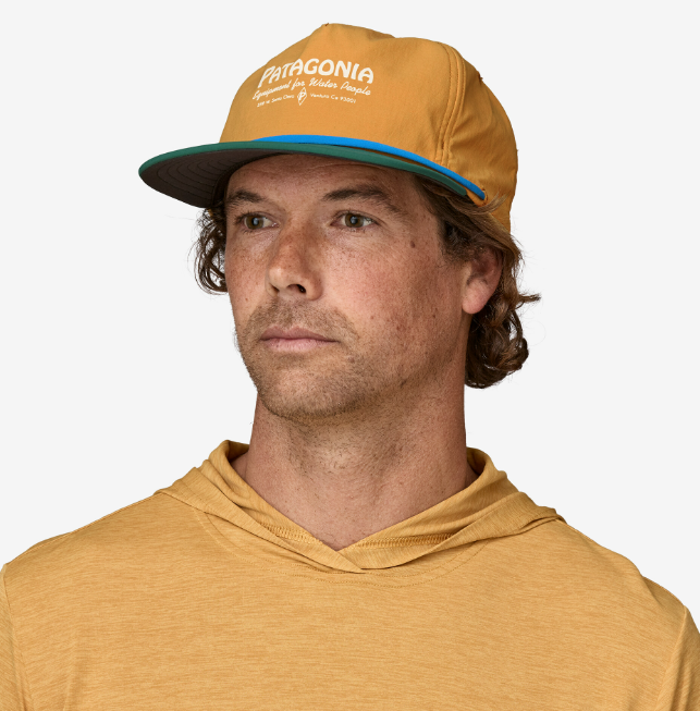 the patagonia merganzer hat in the color water people pufferfish gold, front view on a model