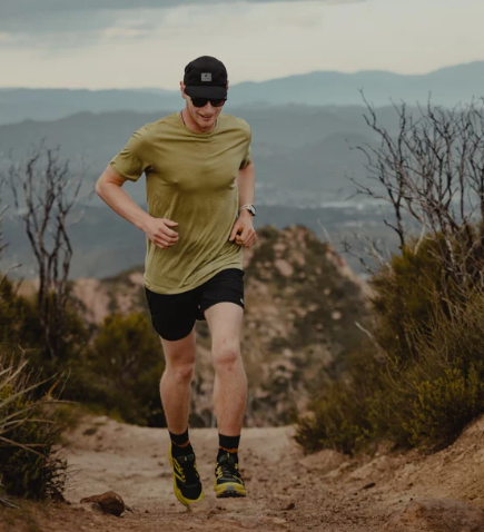 ridge merino journey tee mens in color sage on a model while running