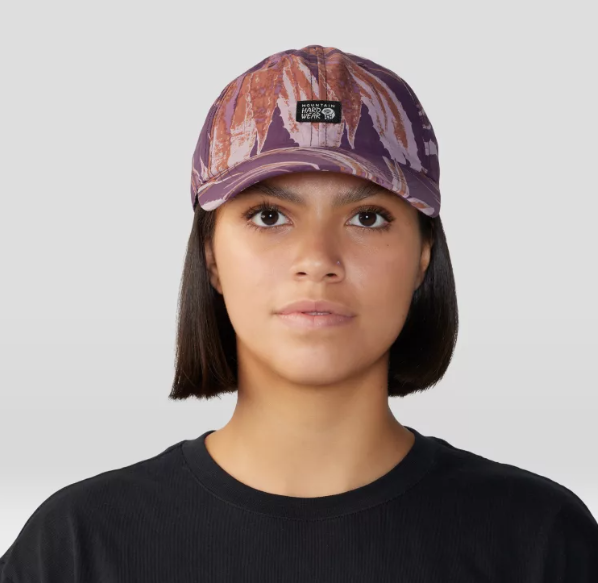 a model wearing the mountain hardwear stryder trek hat in the color dusty purple