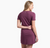 a model wearing the kuhl willa tee shirt dress in the color wine, back view