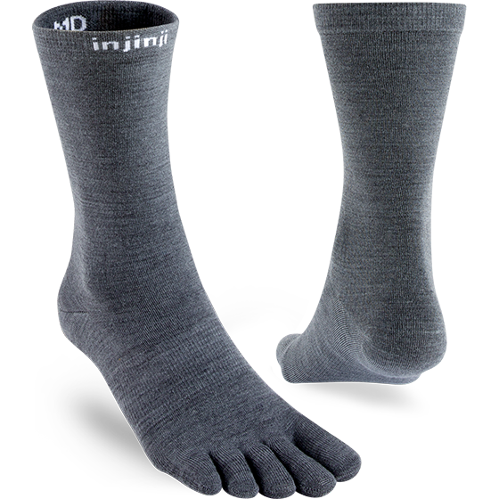 a pair of nuwool liners with one showing the toes, the other the heel