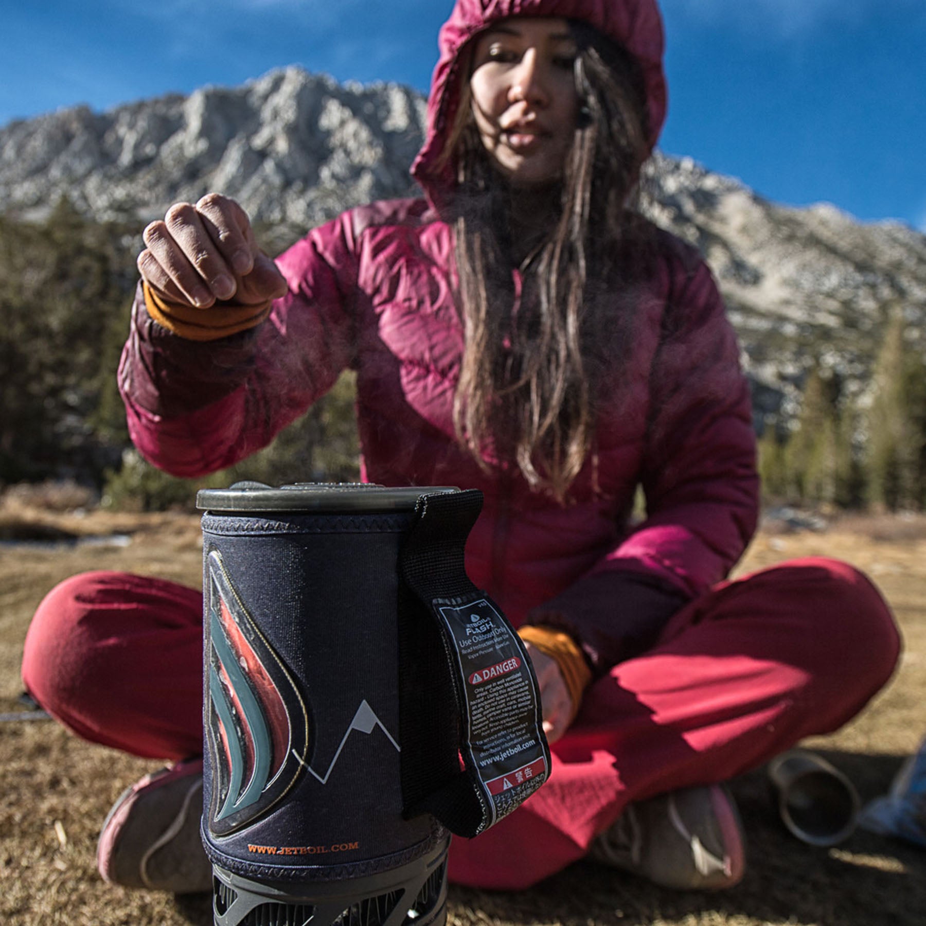 a women prepares to take the lid off a jet boil flash stove