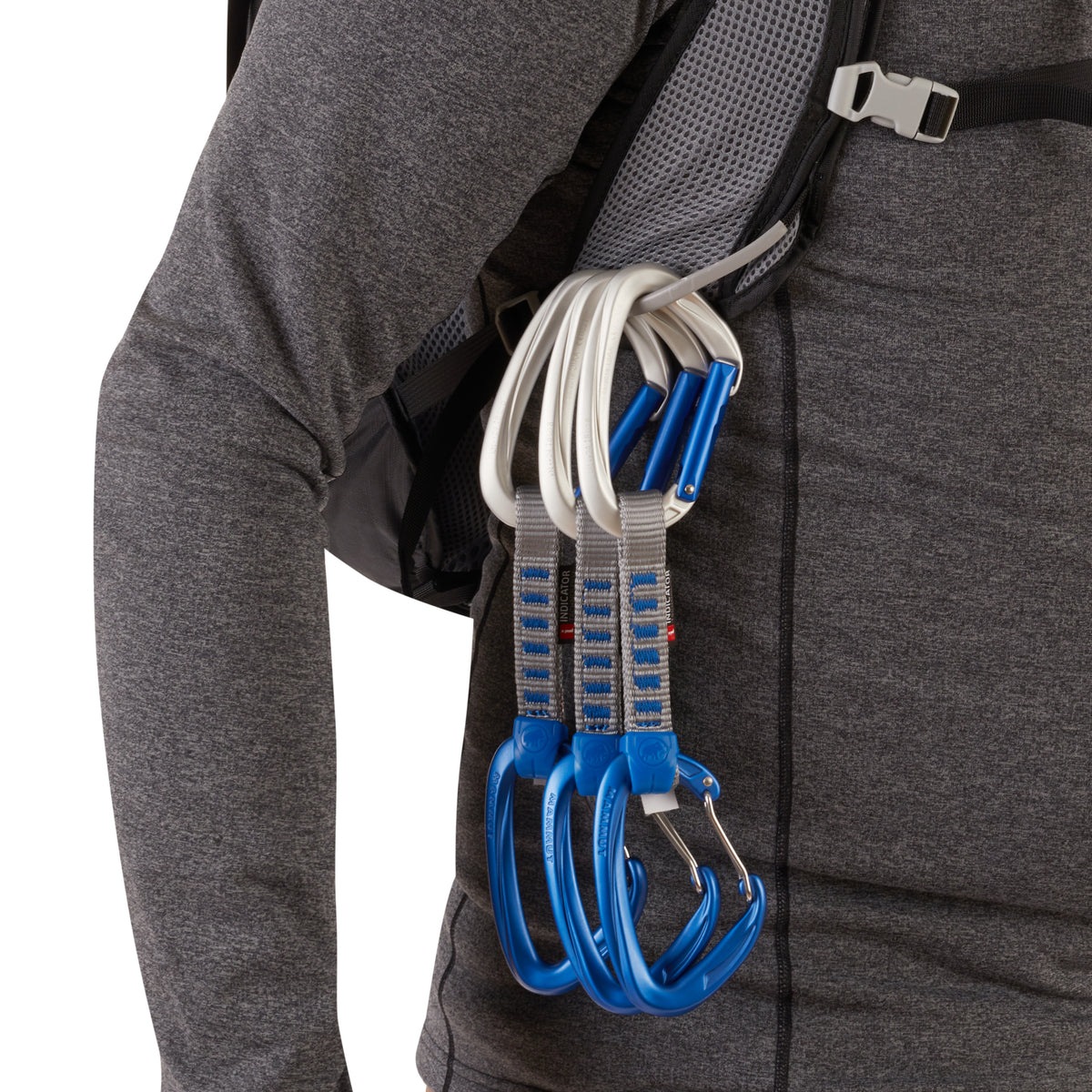 three quick draws are shown clipped to the gear loops on the pack which is being worn by a model