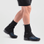 a model wears a pair of ferrosi thru gaiters in black