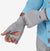 a photo of a model pulling on a pair of the patagonia sung gloves in the color salt grey